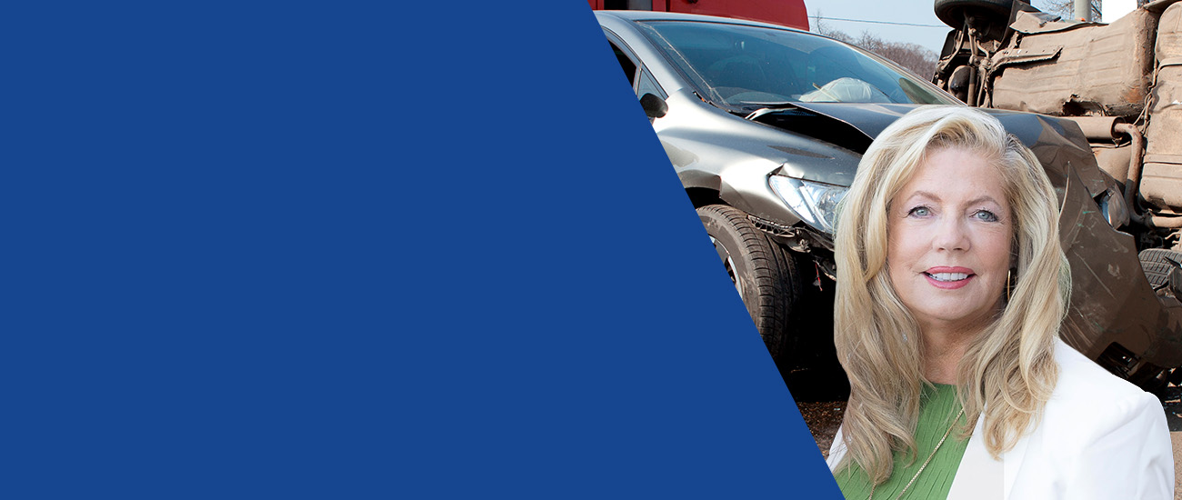 Banner photo of Gretchen Myers standing confidently in front of a car wreck